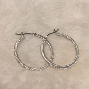 Textured silver hoop earrings.